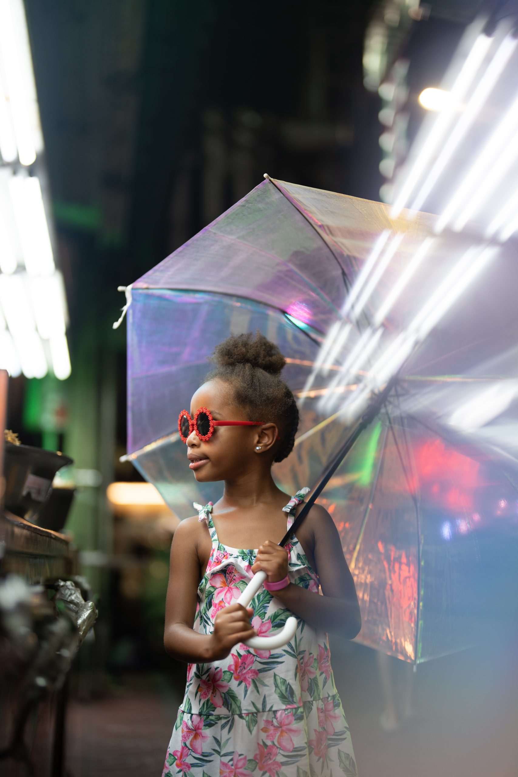 Daughter looking off in the distance, holding a clear umbrella