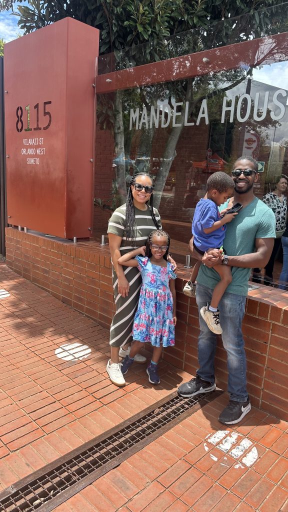 The family stands outside Mandela's home in Soweto, now a museum
